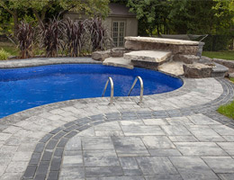 natural stone water feature by pool
