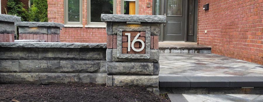 natural stone pilar with the number sixteen